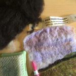 artwork with needle felted hedge and wool and tools